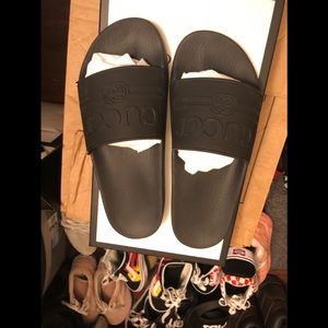 Black Gucci flip flops